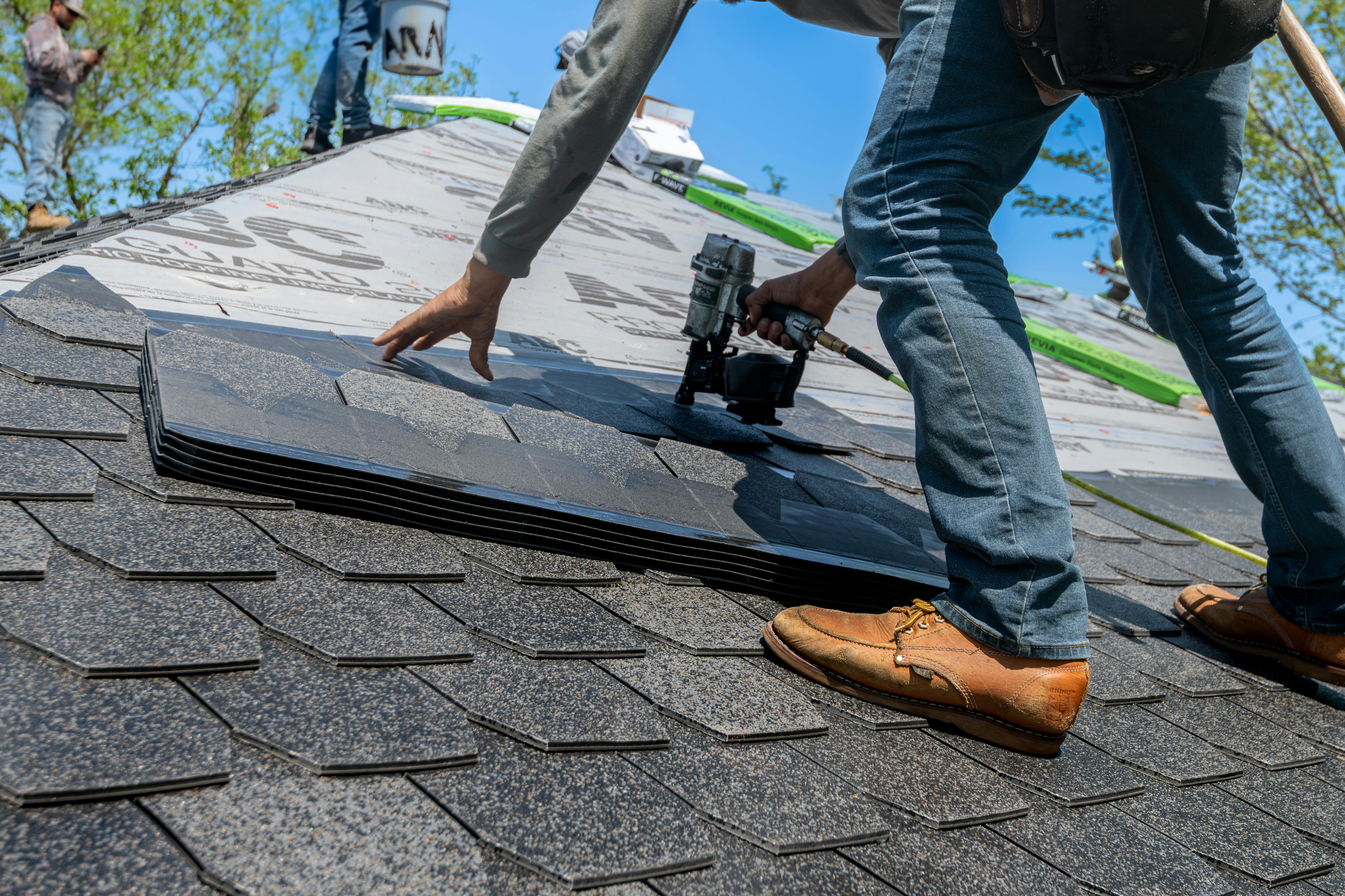 Tradesperson on a roof during roofing work